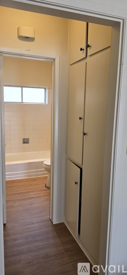 A bathroom with a toilet, tub, and sink.