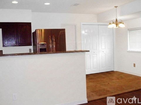 A kitchen with a white counter and a copper refrigerator.
