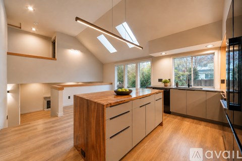 A modern kitchen with wooden cabinets and a central island.