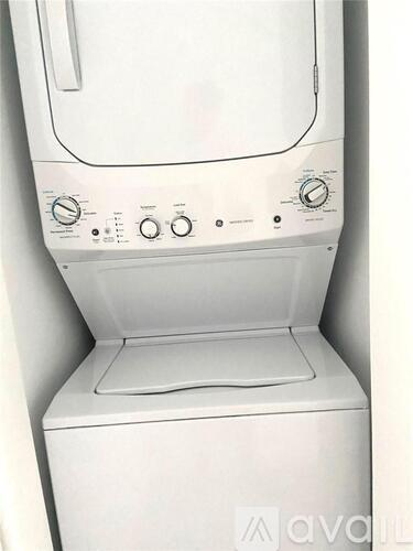 A white front loading washing machine with the door open.
