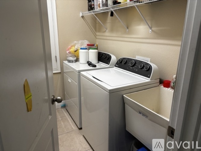 A small, white, built-in dishwasher and washer in a kitchen.