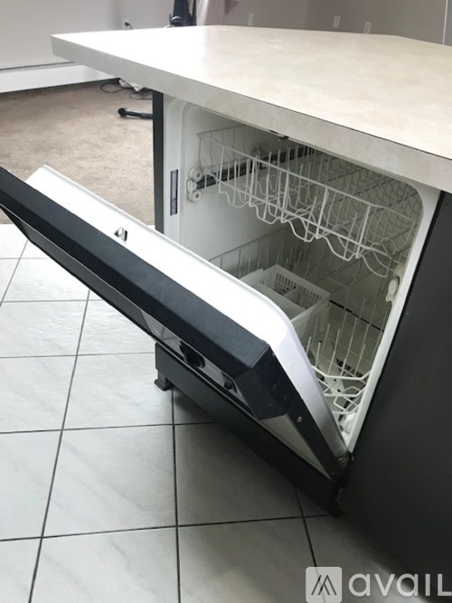 A dishwasher is open and empty.