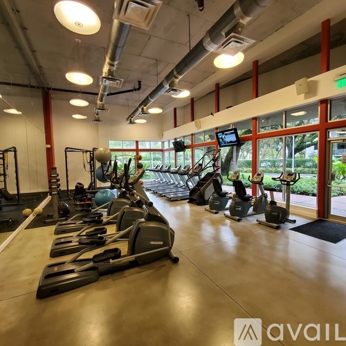 A gym with treadmills, elliptical machines, and other exercise equipment.