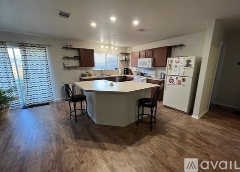 A kitchen with a table and chairs in the middle of the room.