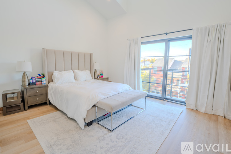 A bedroom with a large bed and a view of the city.