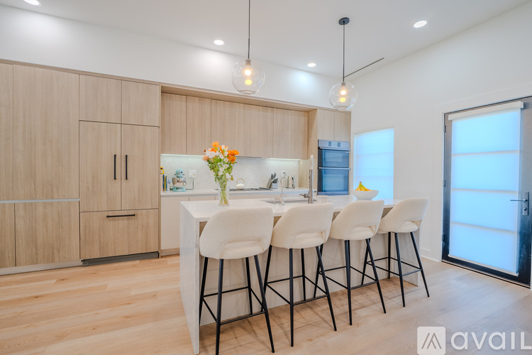 A modern kitchen with a dining table set for four.