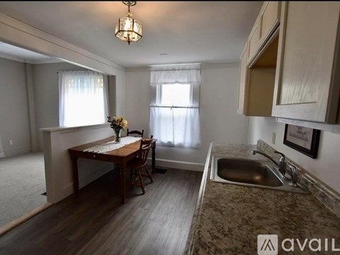 A kitchen with a table and chairs in the middle of the room.