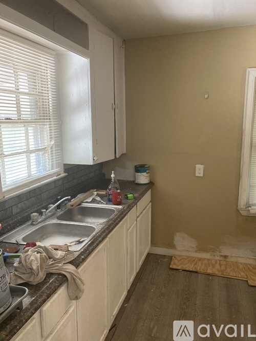 A kitchen with a sink and a window.