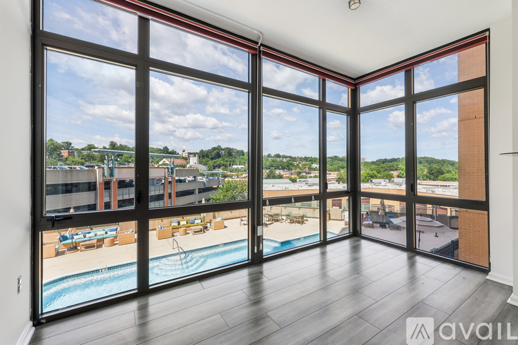 A large room with a pool and a view of the outside.