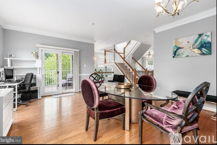 A dining room with a glass table and chairs.