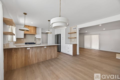 A modern kitchen with wooden cabinets and a central island.