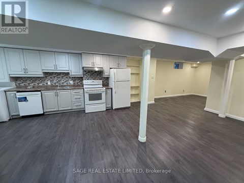 A kitchen with white appliances and cabinets is shown in this image.