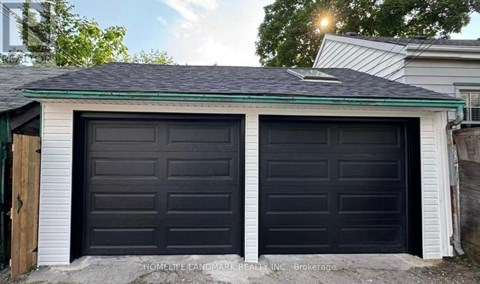 A black double garage door is closed.