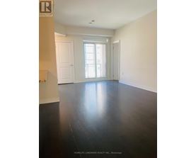 A room with a wooden floor and white walls.