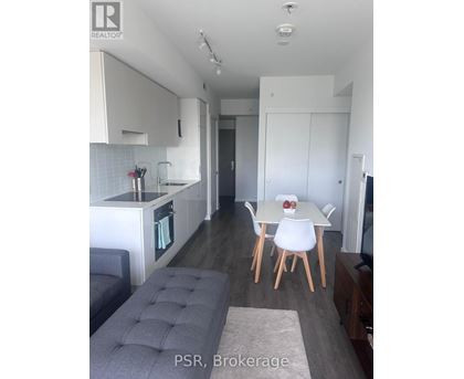 A modern kitchen with a dining table set for two.