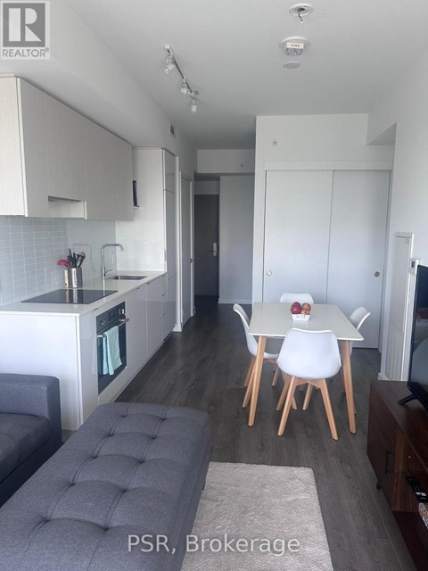 A modern kitchen with a dining table set for two.