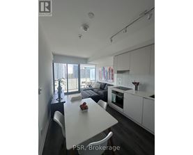 A modern kitchen with a dining table and chairs.