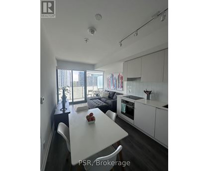 A modern kitchen with a dining table and chairs.