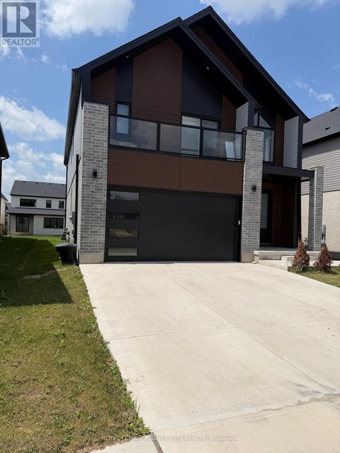 A modern house with a large garage is for sale.