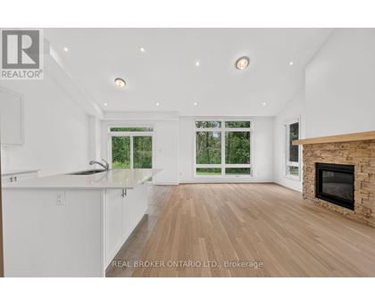 A spacious living room with a fireplace and sliding glass doors.