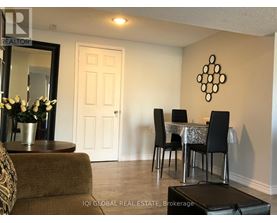 A dining room with a table set for four.
