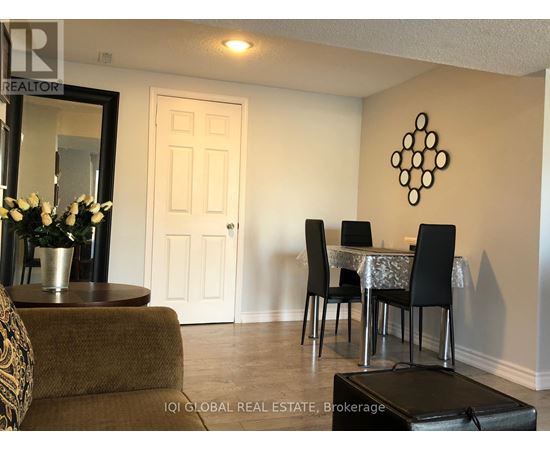 A dining room with a table set for four.