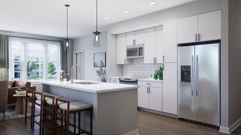 A modern kitchen with a large island and stainless steel appliances.