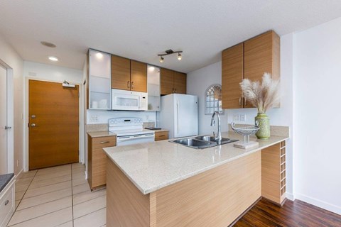 A kitchen with a sink, microwave, and oven.