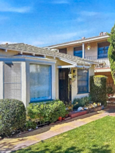 A house with a blue window and a red door.