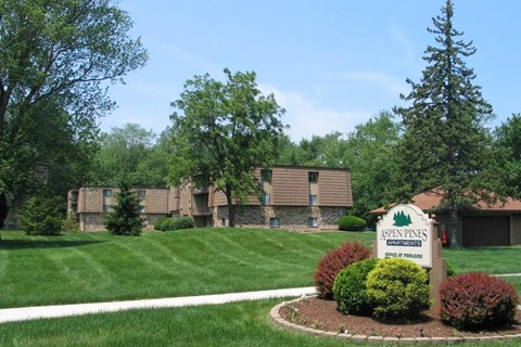 A sign in front of a building that says Aspen Pines.