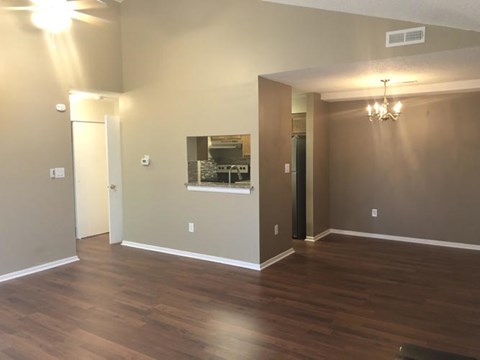 A room with wooden floors and a chandelier.