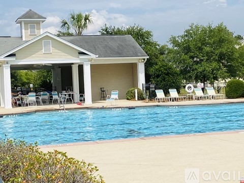 A pool in front of a house with a sign that says "available".