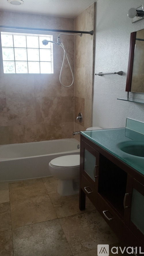 A bathroom with a toilet, sink, and shower.