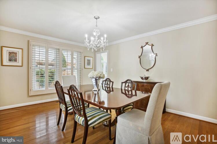 A dining room with a wooden table and chairs.