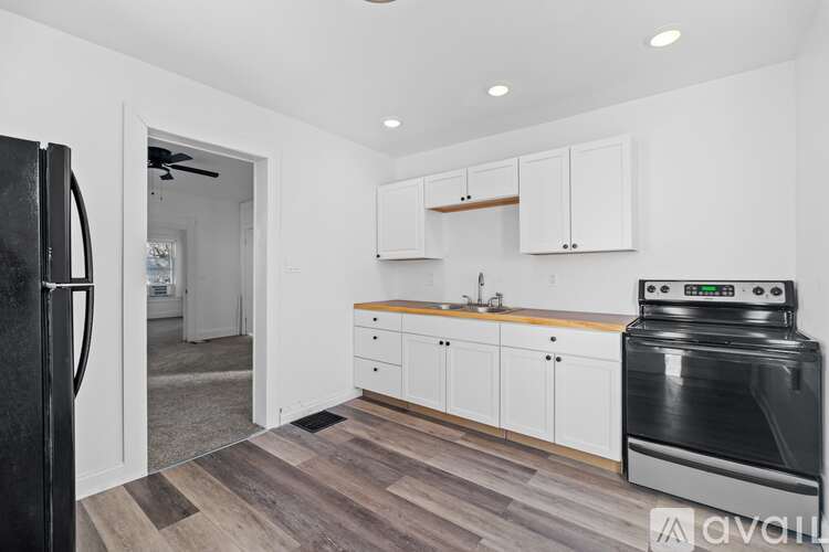 A kitchen with a black fridge and a black stove.