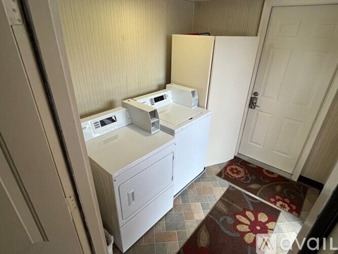A white refrigerator and microwave in a kitchen.