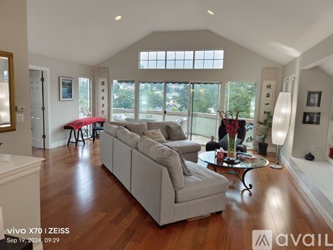 A living room with a grey couch and a coffee table.
