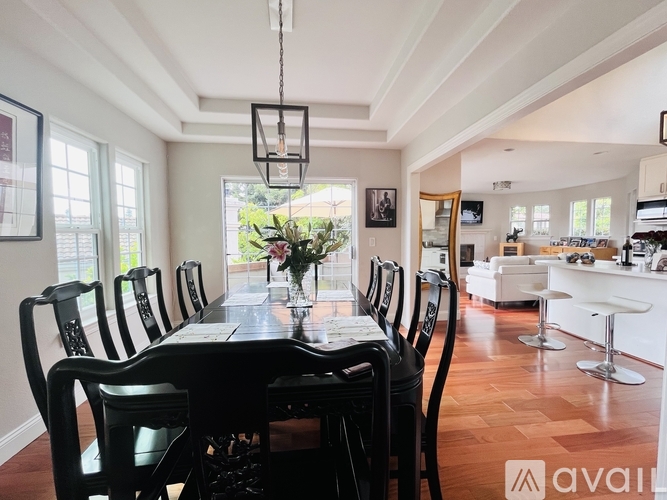 A dining room with a long table and chairs.