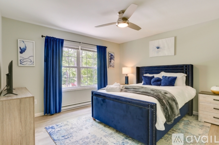 A bedroom with a large bed and a flat screen TV.