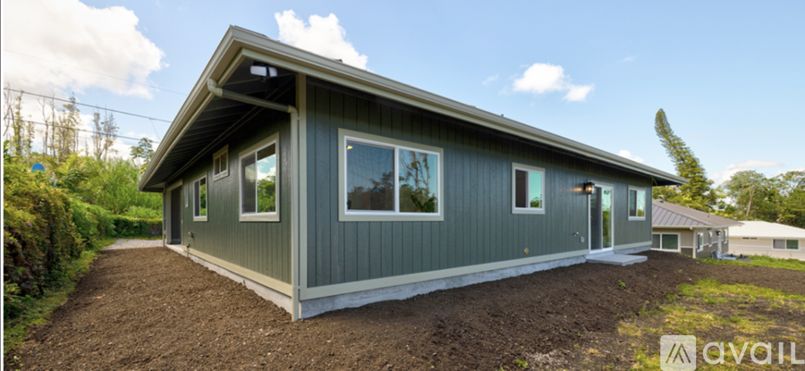 A small house with a grey exterior is available for purchase.