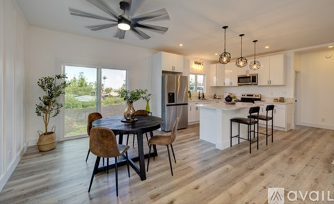 A modern kitchen with a dining table and chairs.