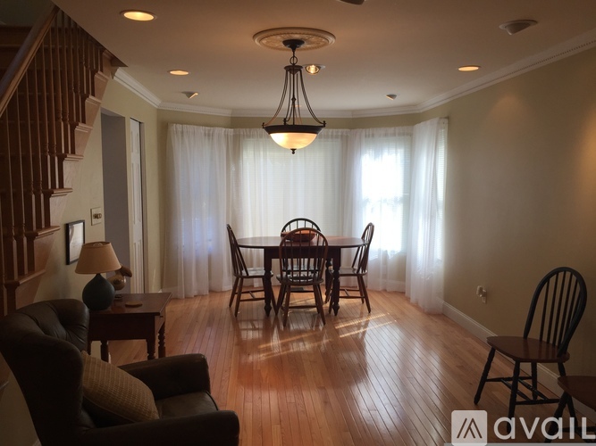A dining room with a wooden table and chairs.