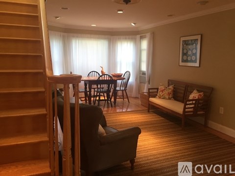 A living room with a dining table and chairs.