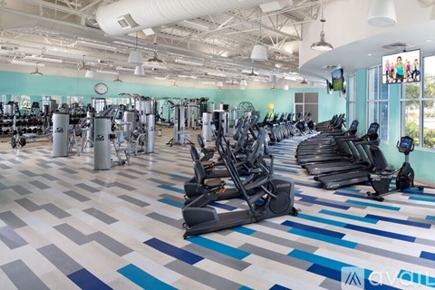 A gym with a variety of exercise equipment.