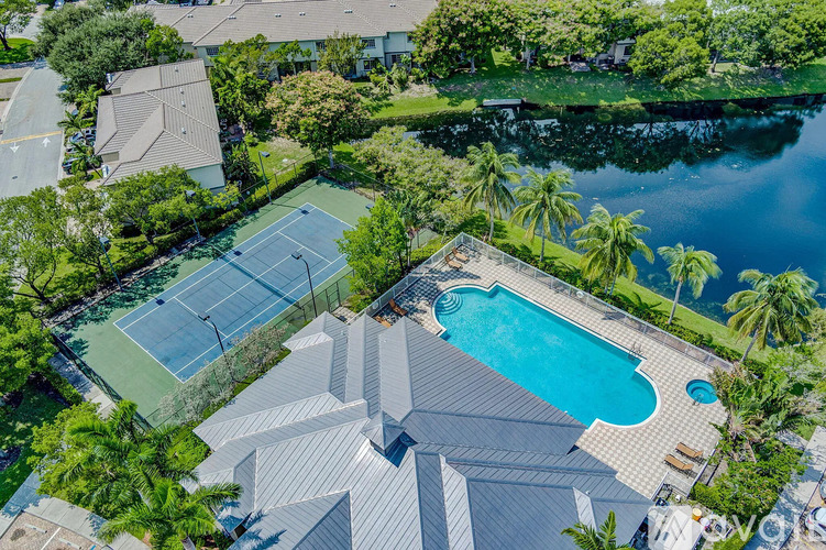 A large house with a tennis court and a pool.