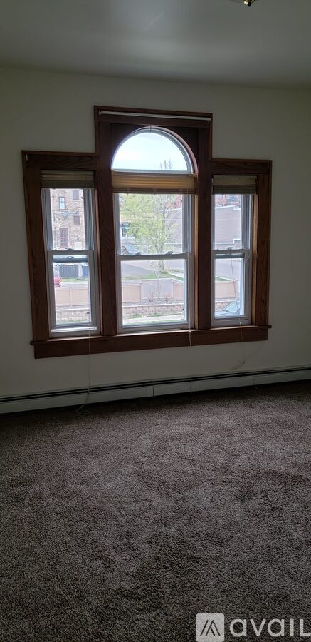 A window with a view of a street and buildings outside.
