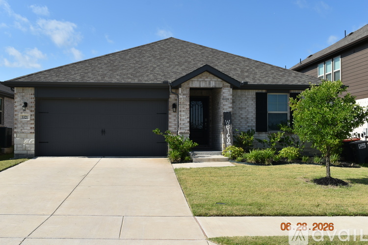 A house with a garage and a driveway in front.