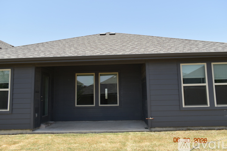 A house with a grey exterior and a black door.