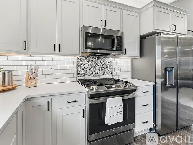 A kitchen with a stove top oven and a refrigerator.