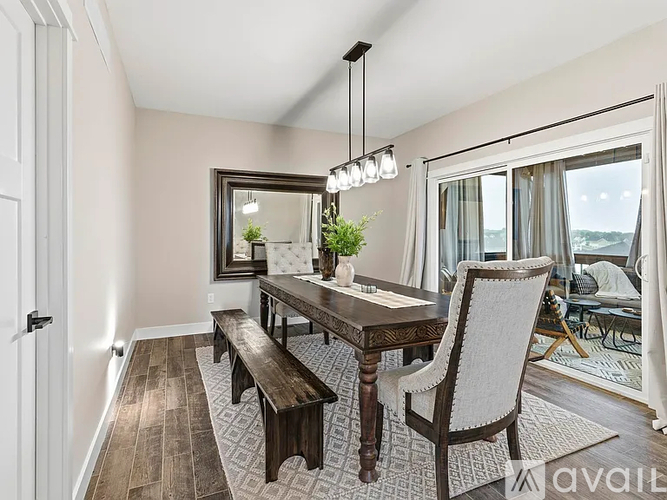 A dining room with a wooden table and chairs.